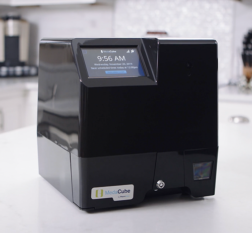 MedaCube sitting on a counter top in a kitchen. 